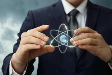 Atom shows in the hands of the businessman .