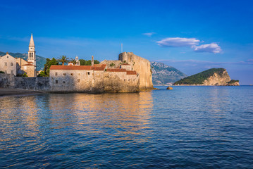 Fototapeta na wymiar Old Town citadel in Budva town over Adriatic Sea, Montenegro. Island of Saint Nicholas on background