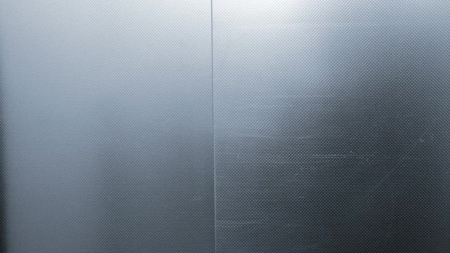 Elevator is arriving and doors open. Blue tone