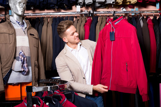 Man choosing new coat