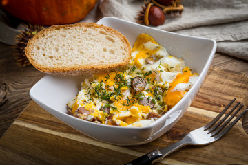 Scrambled eggs with sausage and bread.