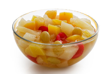 Glass bowl of fruit cocktail isolated on white.
