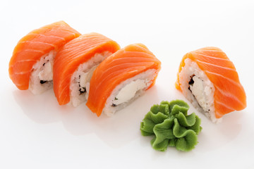 Philadelphia Rolls with red Salmon, cream cheese, rice, nori and green wasabi on a white background. Sushi. Japanese Food. Restaurant eating.