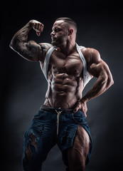 Fototapeta na wymiar portrait of strong Athletic Fitness man showing big muscles