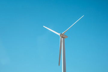 Wind generator against the blue sky