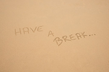 Fototapeta na wymiar Handwritten Have a break in the sand on the beach