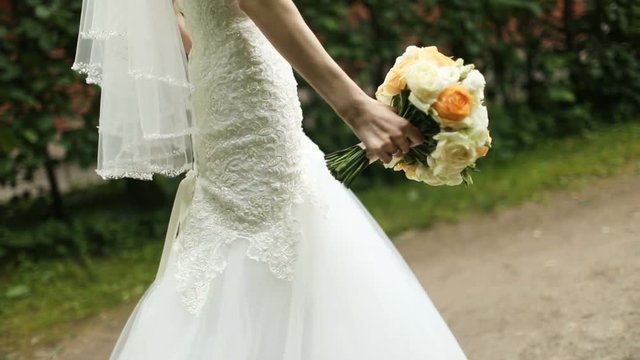 Beautiful wedding bouquet in hands of the bride