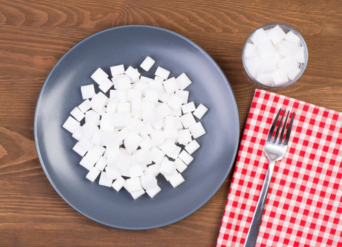 Sugar Cubes On A Plate And In A Glass. Too Much Sugar In Food Concept