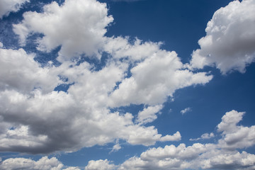 Naklejka na ściany i meble Blue sky with white and gray clouds.