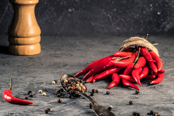 Red hot chilli pepper paprika in and peppers seed ball on stone table