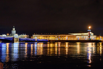 Fototapeta na wymiar Palace Bridge and Vasilyevsky island Spit Strelka with Rostral columns at night. Saint Petersburg, Russia
