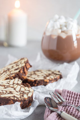 Pieces of chocolate cake from cookies and cocoa with marshmallow on bakery paper