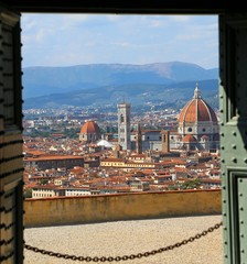Fototapeta na wymiar Open door and the breathtaking.view of Florence in Italy with Dome and Bell Tower