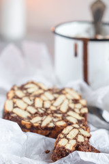 Pieces of chocolate cake from cookies and cocoa with marshmallow on bakery paper High key Still...