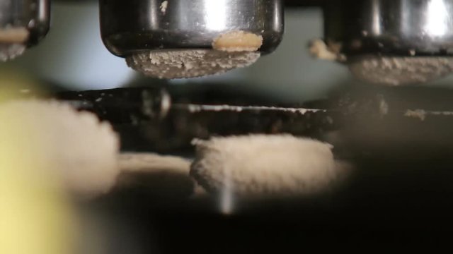 Dough for making oatmeal cookies moves along the conveyor. Dough at the confectionery factory. Making oatmeal cookies. Confectionary factory. Process of producing cookies.