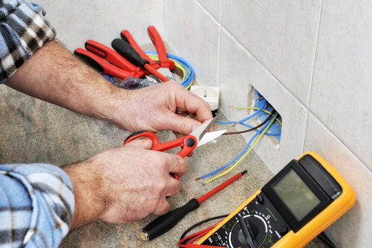 Electrician technician at work on a residential electric system.