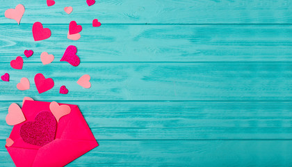 Open envelope with a lot of valentine hearts on a wooden background.Happy moments.Valentines Day background 
