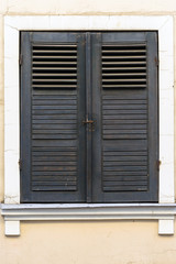 old windows with brown wooden shutter, classic facade