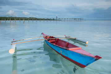 Naklejka premium Traditional fishing Canoe floating on clean sea water.