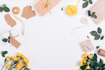 Top view of festive decorations of yellow roses and gift boxes