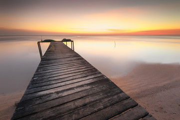 Fototapeta na wymiar wooden jetty during sunset at Kudat Sabah Malaysia. soft focus and blur due to long expose.