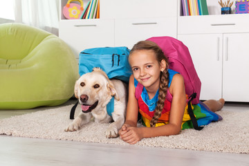 Young girl and her labrador dog ready for school