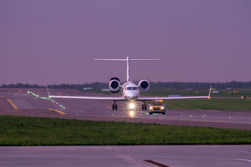 Business jet taxiing on airport runway after 