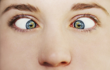 Obraz premium Young woman making goofy face being naughty prankster with twisted eyes. Grimacing female actress. Close up 