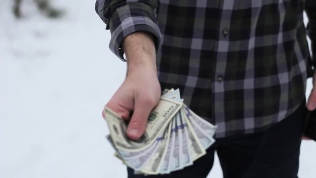 a man with dolor bills in his hands