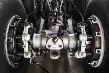 Close-up high detailed view of main landing gear of big wide-body passenger aircraft.