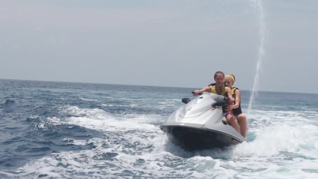 Two Friends Driving With The Jet Boat On The Sea