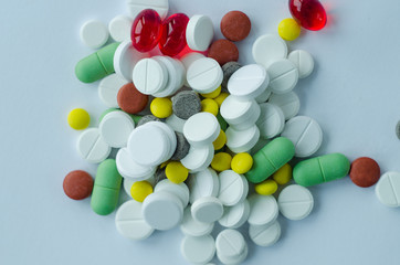Top view scattered medicine pills and tablets on a blue background