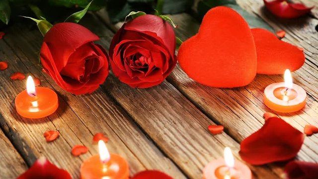 Red Roses and romantic candles on old wooden table, Valentine's day