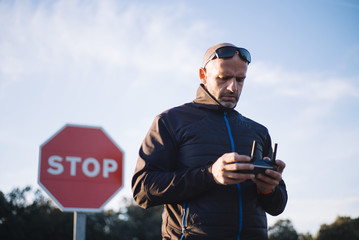 Man flying drone with the stop sign