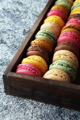 Sweet and colourful french macaroons or macaron on grey background, Dessert