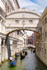 Gondolas under the Bridge of Sighs, a romantic tradition in Venice
