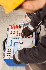 Maintenance engineer inspect system with relay test set equipment