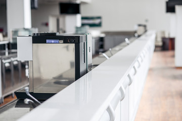 Modern coffee machine for a white bar.