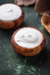 White Greek yogurt in wooden bowl
