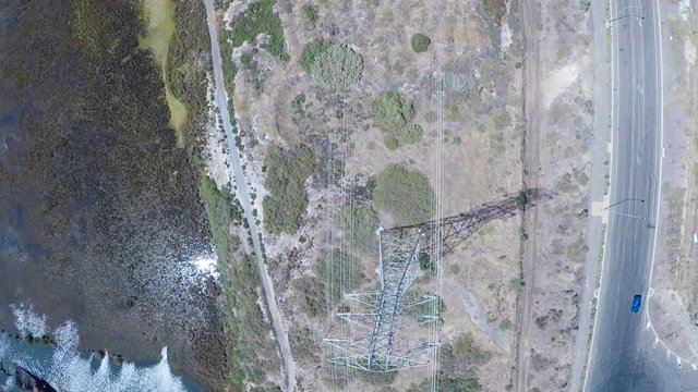 Drone footage of remote industrial area near power station and high-voltage towers, taken at Outer Harbor, Port Adelaide, South Australia.