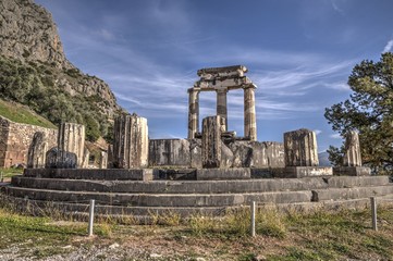 Fototapeta na wymiar Ruins of Athina Pronaia temple in Ancient Delphi archeological site in Fokida, Greece