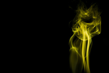 Obraz premium Yellow smoke on black background