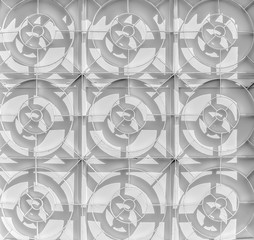 A white painted lattice on a blind plant window with shadows from the sun