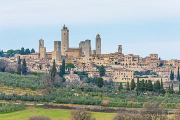 Fototapeta na wymiar San Gimignano (Italy) - The famous small walled medieval hill town in the province of Siena, Tuscany. Known as the Town of Fine Towers, or the Medieval Manhattan. Here the awesome historic center.