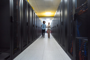 engineer showing working data center server room to female chief