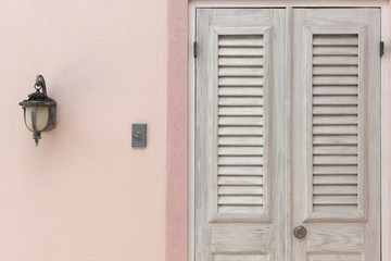 Wooden Door, Doorbell, and Sidelight on Pink Wall