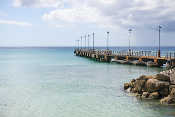 Pier Leading to Calm Blue Ocean at Daytime