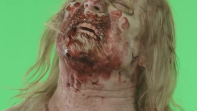 Closeup of a zombie face on green screen