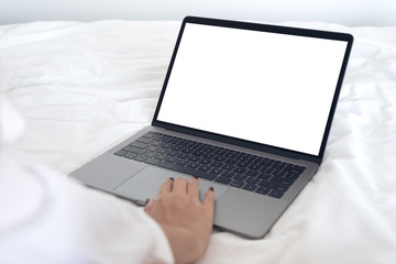 Mockup image of woman's hands using and touching on laptop with blank white desktop