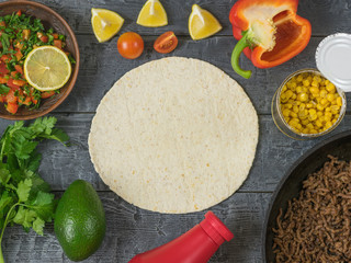 Cake made of corn flour, avocado, pepper, lemon, lime, parsley, corn and herbs. The view from the top.